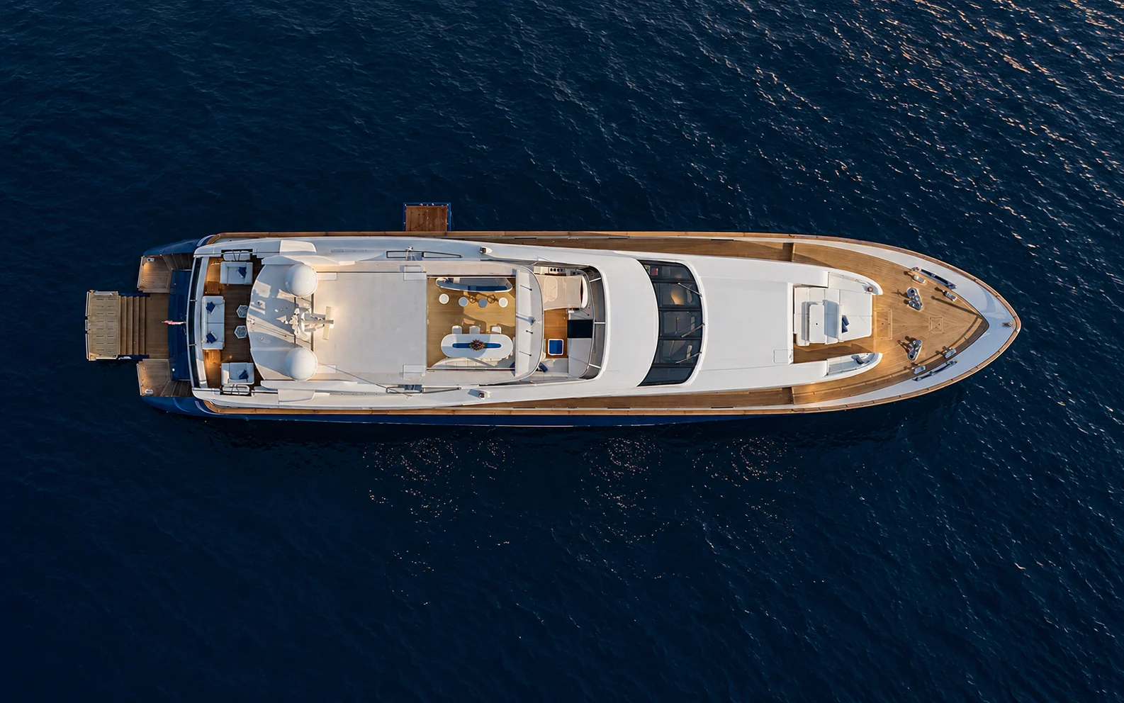 CEZZ OF LONDON from directly above on deep blue water, her upper decks in full view